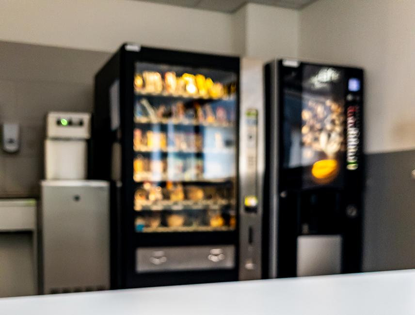 Plastic,Coffee,Cup,Of,Vending,Machine,Standing,On,Table.